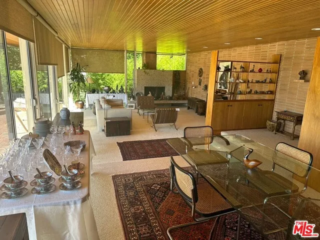 a large kitchen with kitchen island a large counter top space a sink stainless steel appliances and cabinets