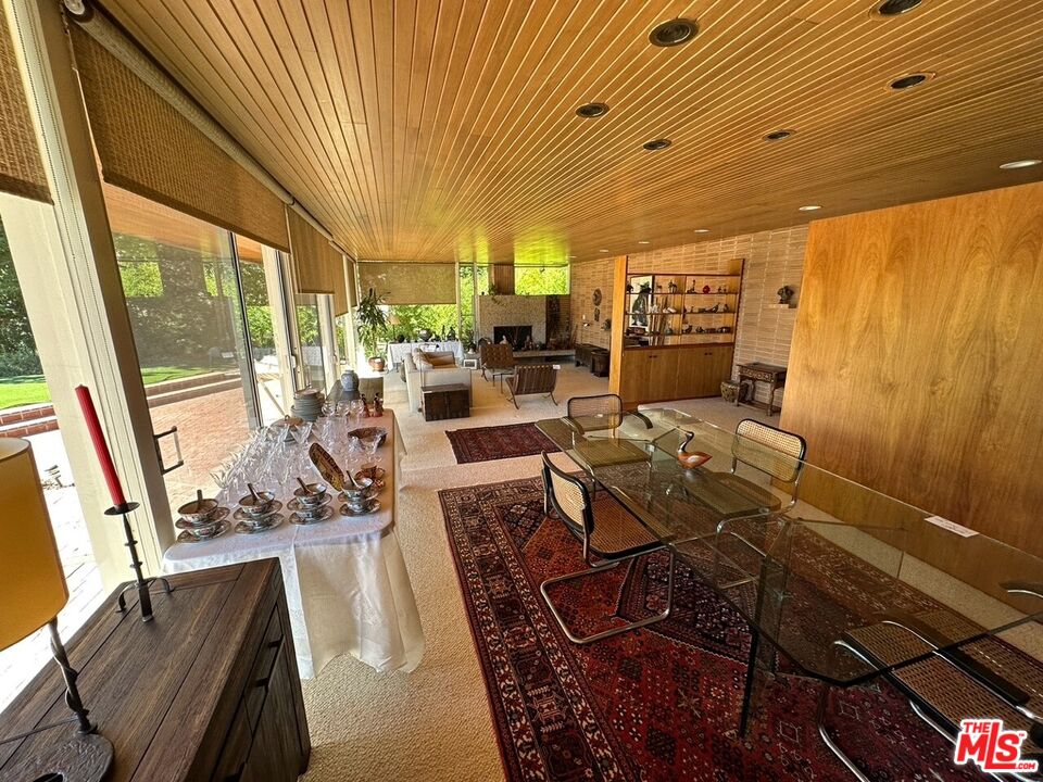 590 North Tigertail Road Los Angeles, CA 90049 - Photo 26 of 69 a view of a dining room with furniture window and outside view