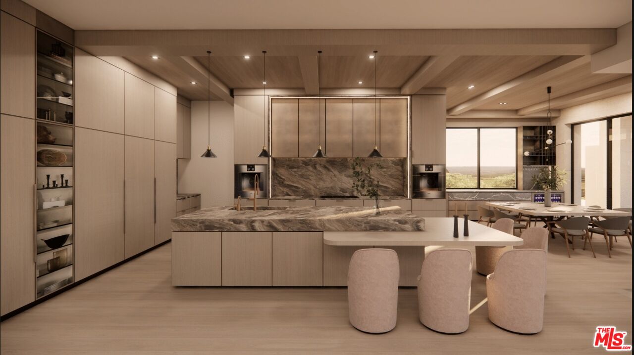 590 North Tigertail Road Los Angeles, CA 90049 - Photo 38 of 69 a large kitchen with kitchen island a large counter top space a sink stainless steel appliances and cabinets