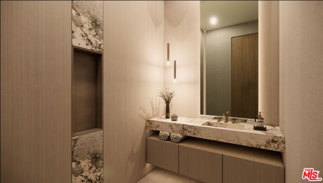 590 North Tigertail Road Los Angeles, CA 90049 - Photo 45 of 69 a bathroom with a sink and a mirror