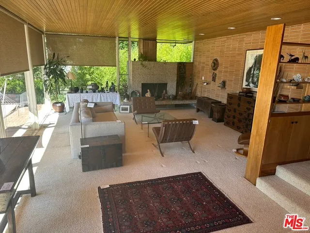 a living room with furniture a patio door and a flat screen tv