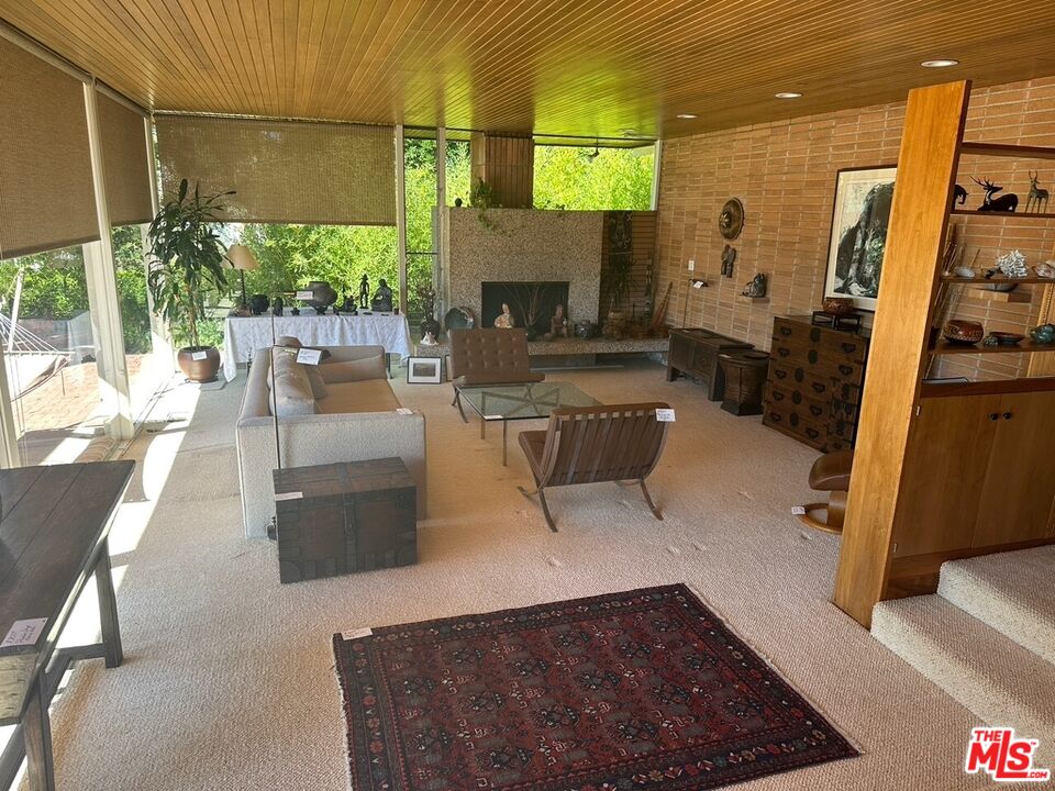 590 North Tigertail Road Los Angeles, CA 90049 - Photo 5 of 69 a living room with couches and a flat screen tv