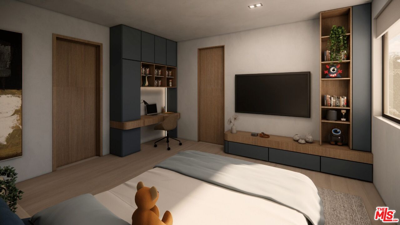 590 North Tigertail Road Los Angeles, CA 90049 - Photo 62 of 69 a bedroom with a bed and a flat tv screen on wall