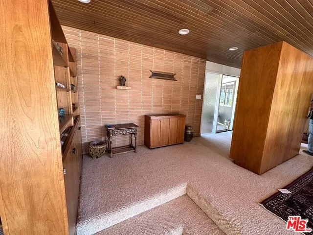 a bed room with a bed and large windows