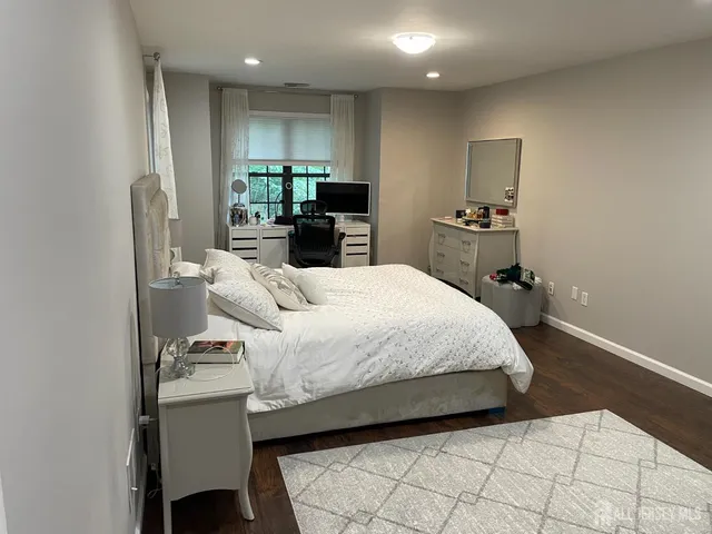 a spacious bedroom with a bed and a view of bathroom