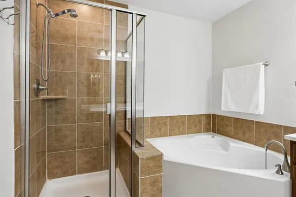 a bathroom with a bathtub and shower