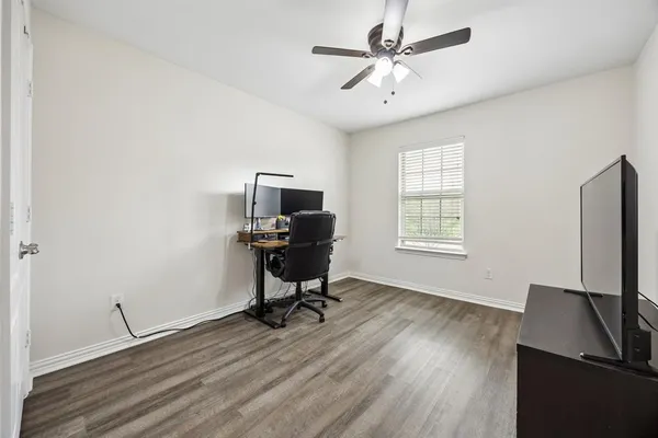 a view of a workspace with furniture and a window