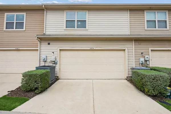 a front view of a house with a garage