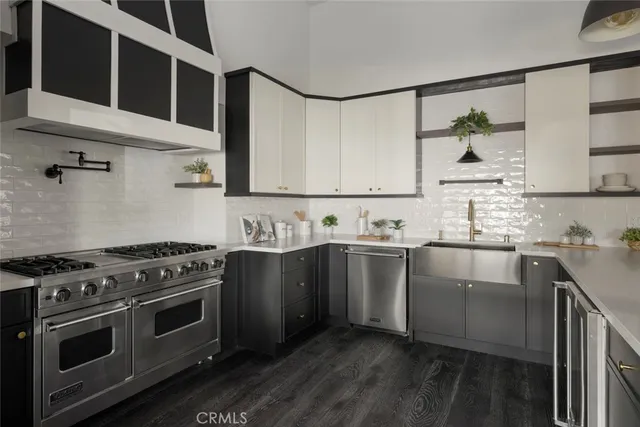 a kitchen with stainless steel appliances granite countertop a stove and a sink