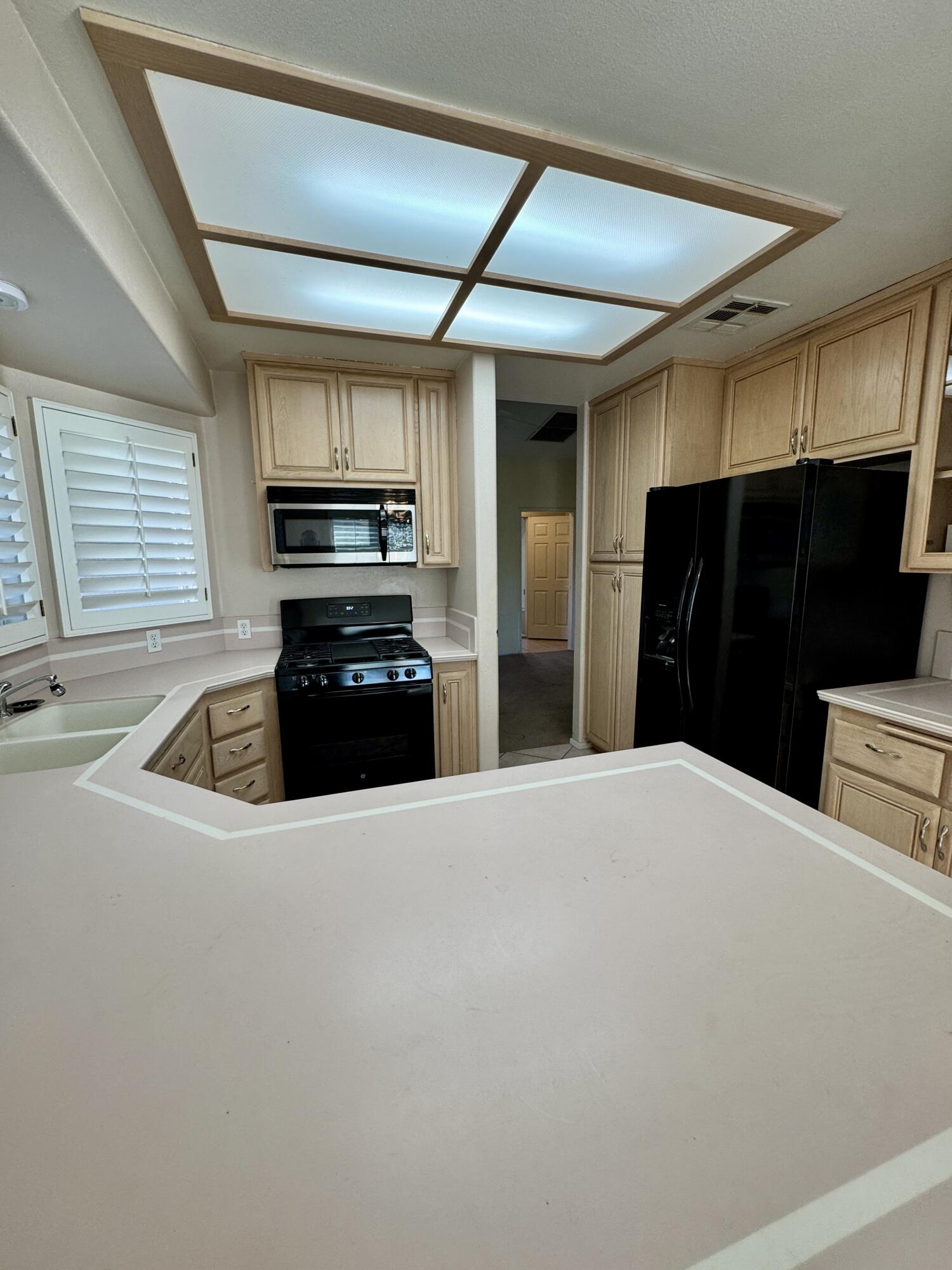 79585 Star Flower Trail La Quinta, CA 92253 - Photo 15 of 21 a kitchen with granite countertop a refrigerator and a stove top oven