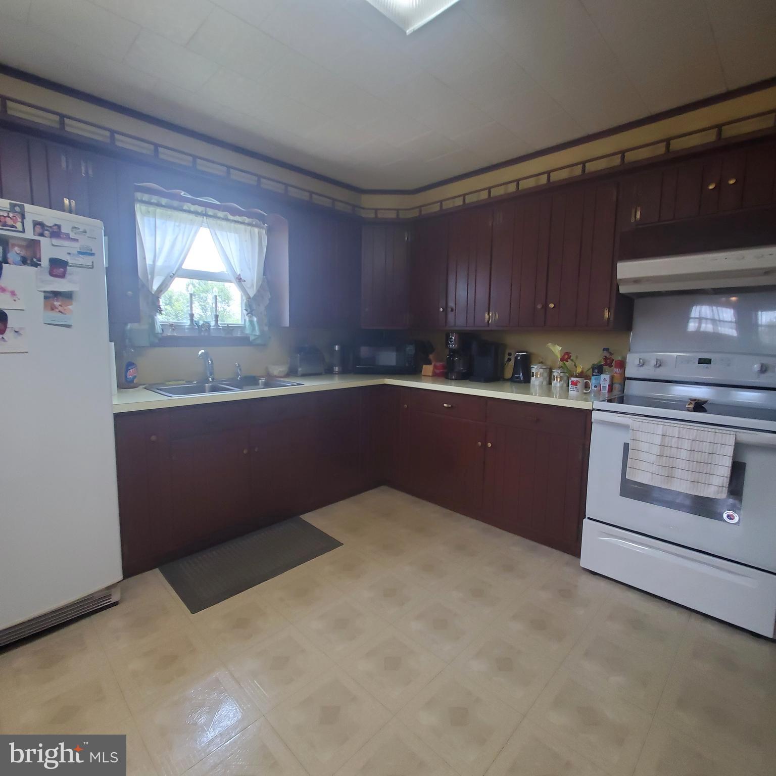 68 Amwellbury Road Salem, NJ 08079 - Photo 11 of 23 a kitchen with granite countertop a sink and cabinets