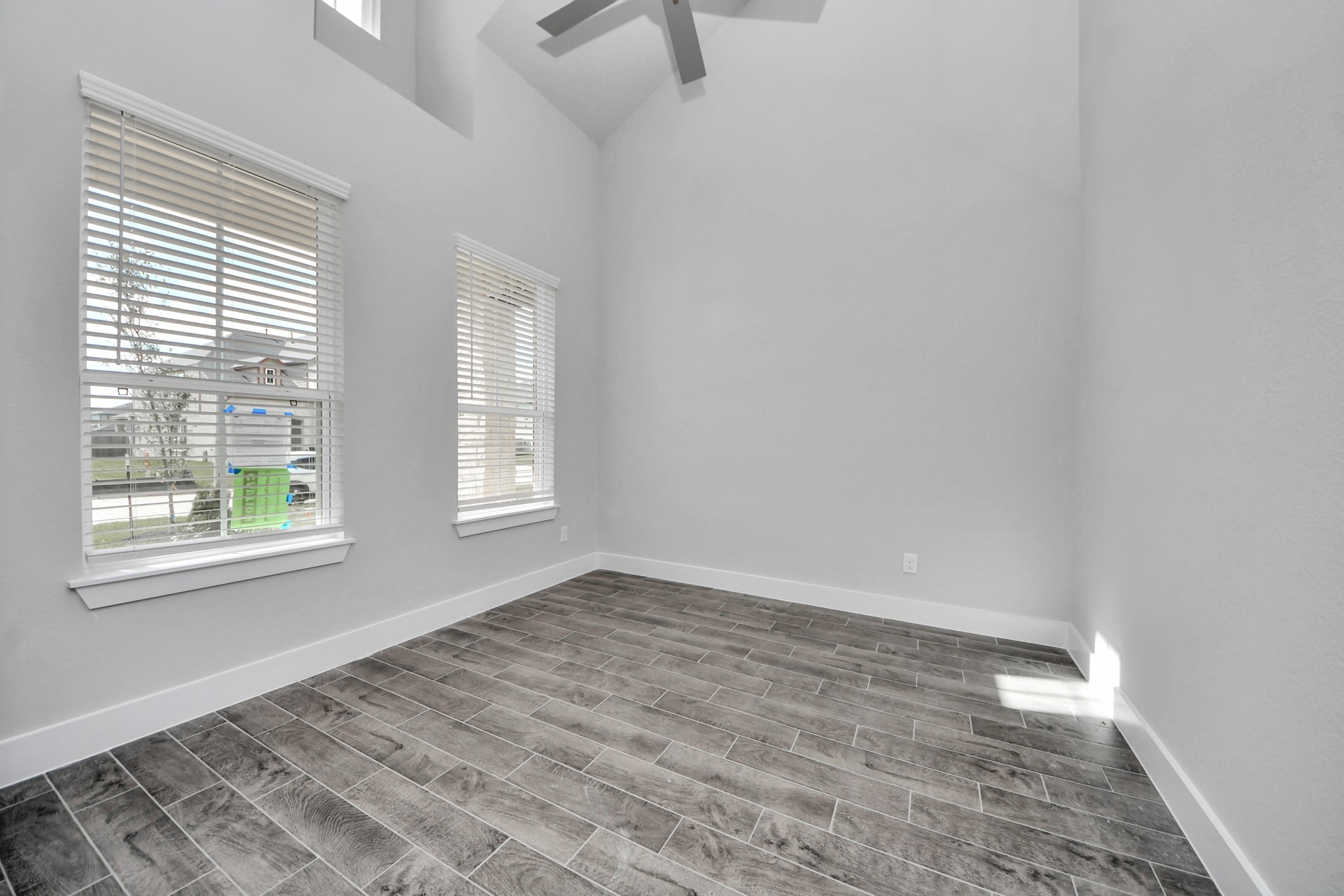 3023 Native Spg Drive Spring, TX 77373 - Photo 8 of 50 Step into the inviting home office, where elegant tile flooring adds a touch of freshness and comfort to the workspace. Natural light pours through the window, creating an inspiring environment for productivity and focus.
