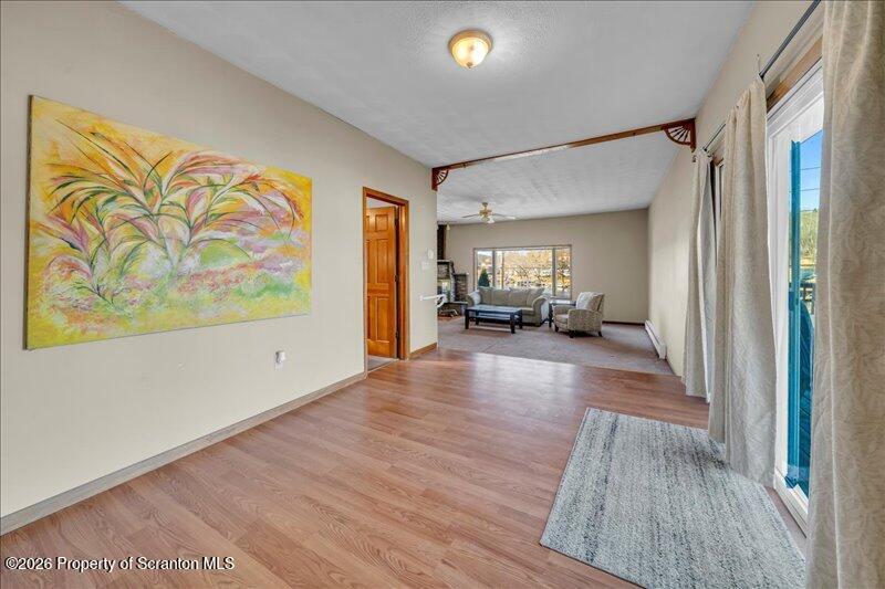 1228 Lake Road Factoryville, PA 18419 - Photo 24 of 43 a view of a hallway with wooden floor and furniture