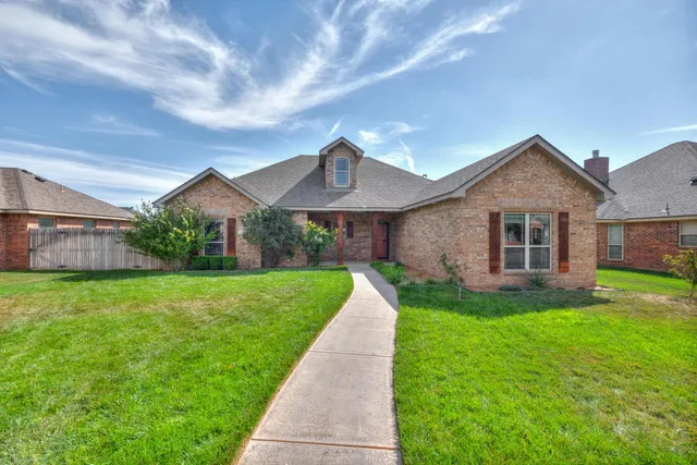a front view of a house with a yard and pathway