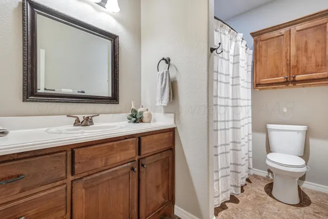 an empty room with a ceiling fan and a fan