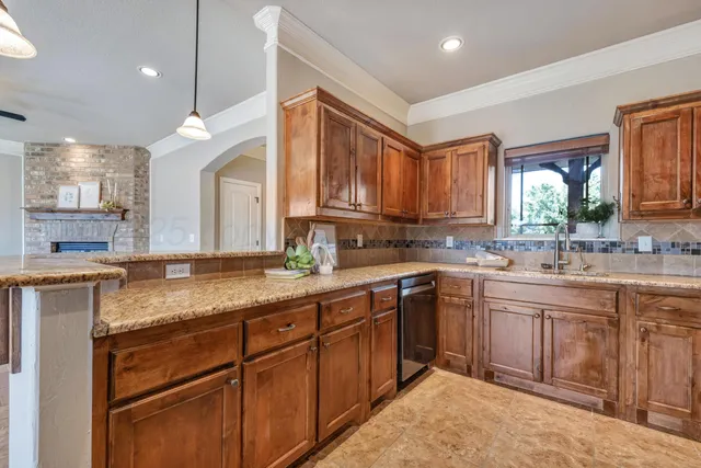 a kitchen with a sink stove and cabinets