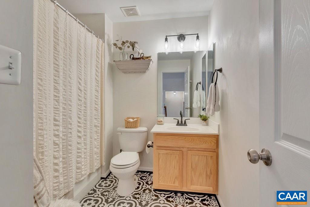 357 Rolkin Road Charlottesville, VA 22911 - Photo 18 of 37 a bathroom with a toilet sink and mirror