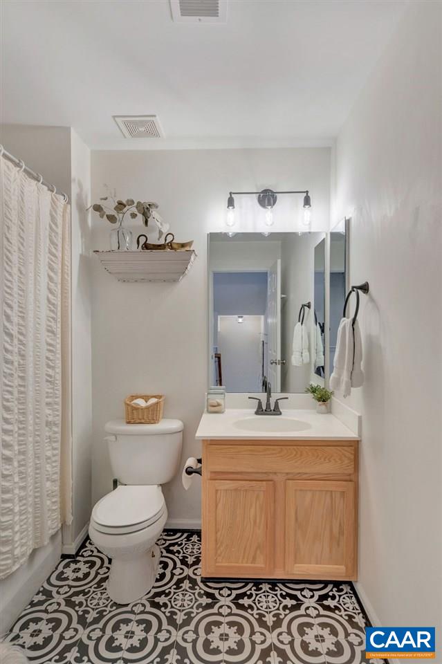 357 Rolkin Road Charlottesville, VA 22911 - Photo 19 of 37 a bathroom with a sink toilet and mirror