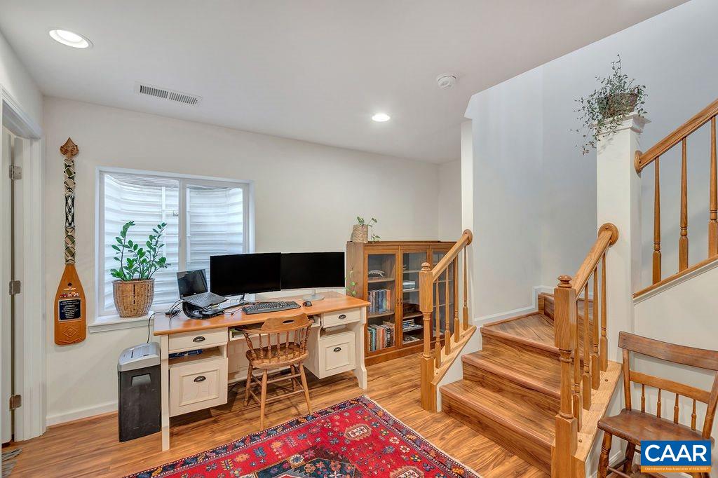 357 Rolkin Road Charlottesville, VA 22911 - Photo 25 of 37 a view of a workspace with furniture and a flat screen tv