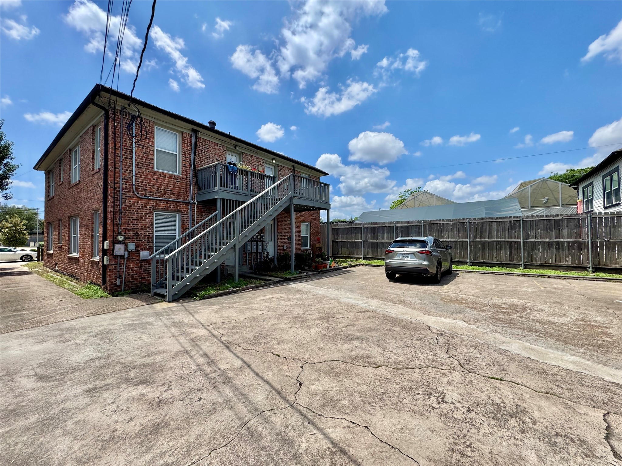 629 East 11th Street, Unit 4 Houston, TX 77008 - Photo 6 of 29 Wide parking area with assigned spots. One uncovered spot will be assigned to Unit 4!