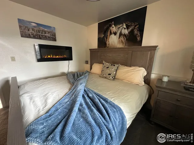 a bedroom with a bed and wall painting