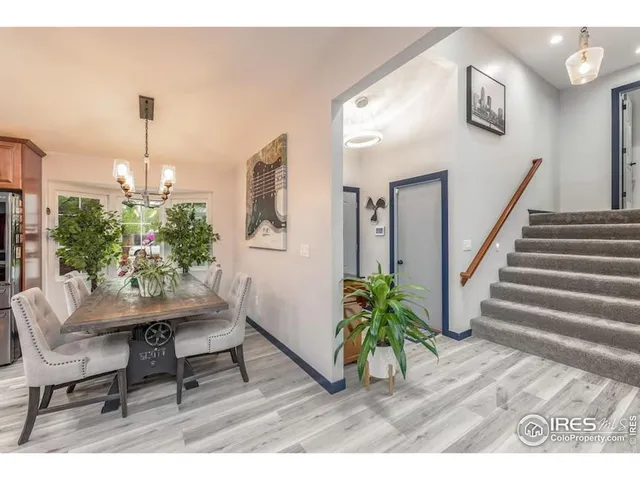 a dining room with furniture and a potted plant