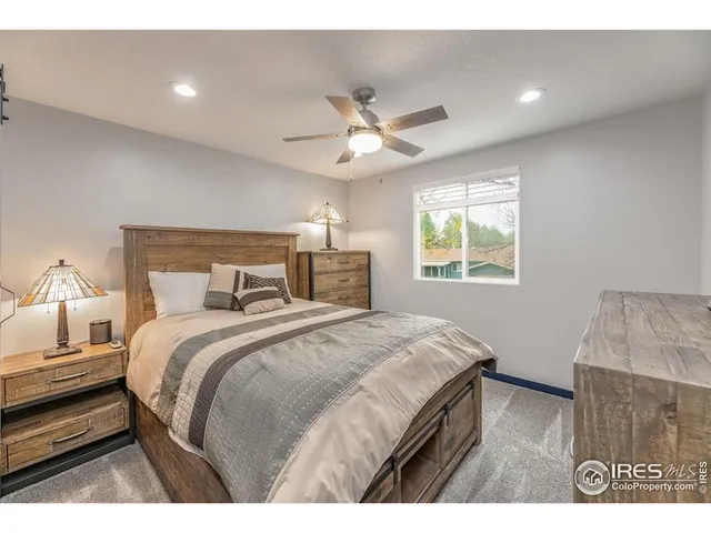 a bedroom with a bed and a night stand