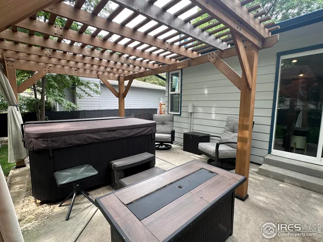 a backyard of a house with table and chairs