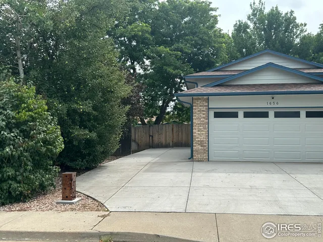 a house that has a tree in front of it