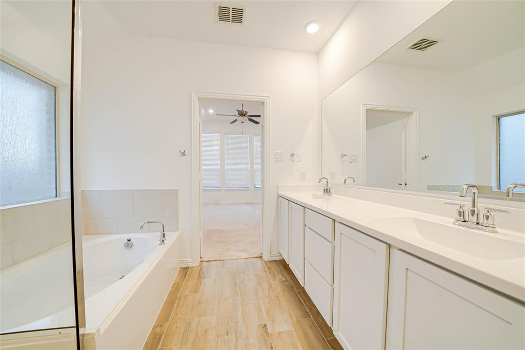 3420 Prairie Place McKinney, TX 75071 - Photo 17 of 37 a spacious bathroom with a tub sink and mirror