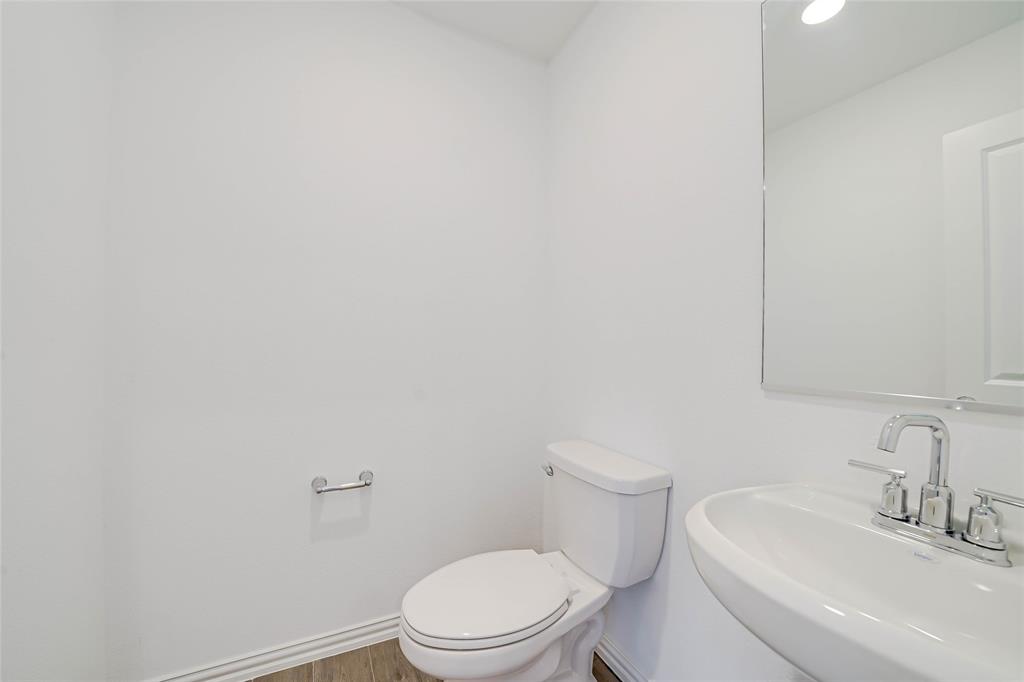 3420 Prairie Place McKinney, TX 75071 - Photo 26 of 37 a white toilet sitting next to a bathroom sink