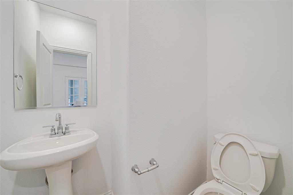 3420 Prairie Place McKinney, TX 75071 - Photo 30 of 37 a bathroom with a sink mirror and toilet