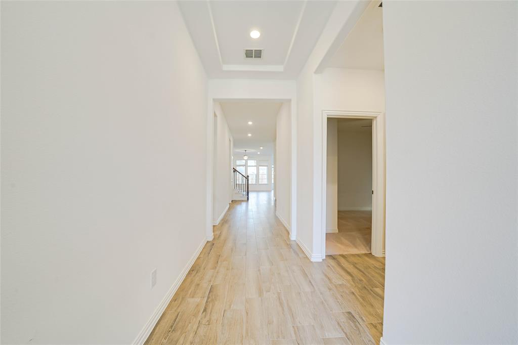 3420 Prairie Place McKinney, TX 75071 - Photo 3 of 37 a view of a hallway with wooden floor
