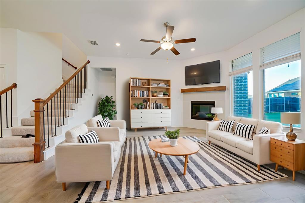 3420 Prairie Place McKinney, TX 75071 - Photo 4 of 37 a living room with furniture fireplace and a flat screen tv