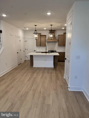 a large kitchen with stainless steel appliances granite countertop a large counter top a sink and a stove