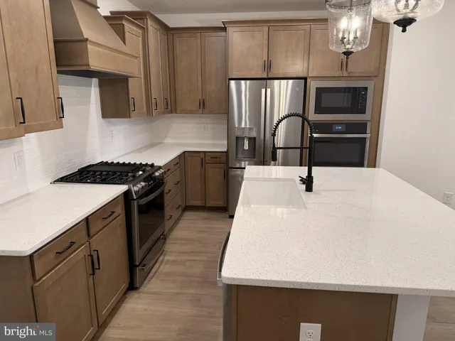 a kitchen with a sink stainless steel appliances and cabinets