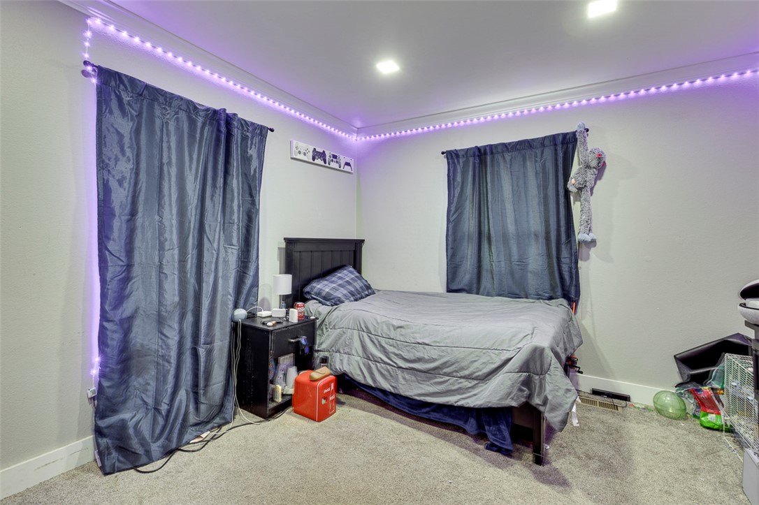 110 Avondale Road Anderson, SC 29624 - Photo 14 of 26 A well-lit bedroom features plush carpeting and streamlined window treatments for comfortable living.
