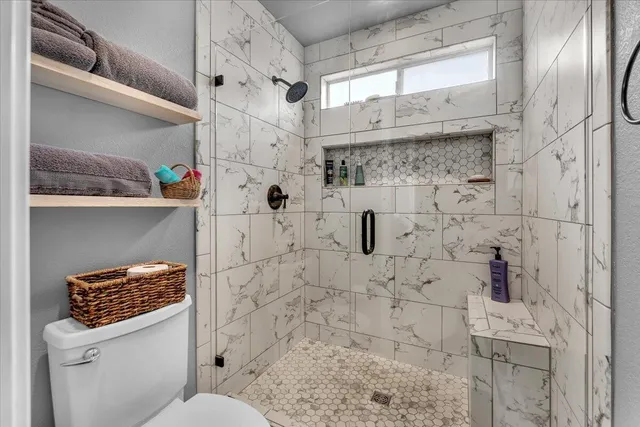 a bathroom with a toilet sink and shower