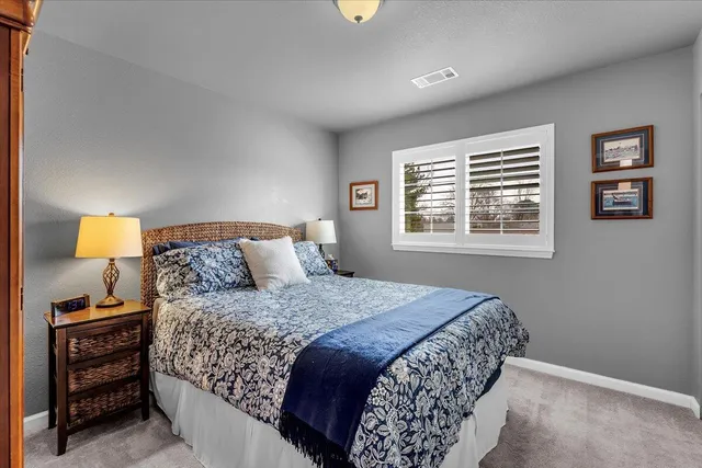 a bedroom with a bed and a lamp