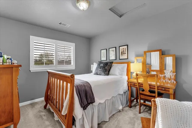 a bedroom with a bed and a table