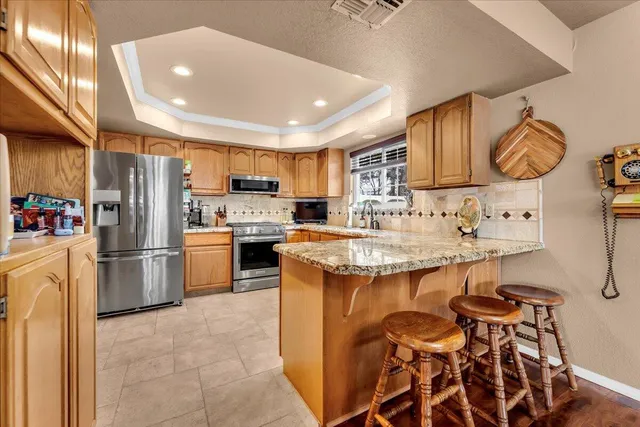 a kitchen with a refrigerator and a sink