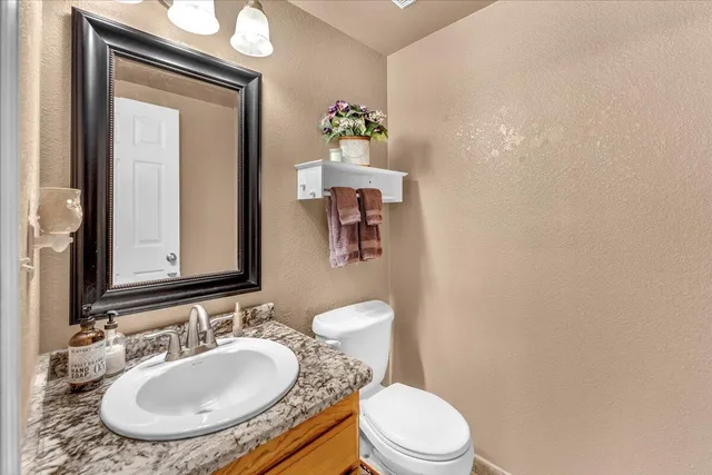 a bathroom with a sink a toilet and mirror