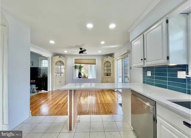 a kitchen with kitchen island granite countertop a coffee maker a sink and a refrigerator