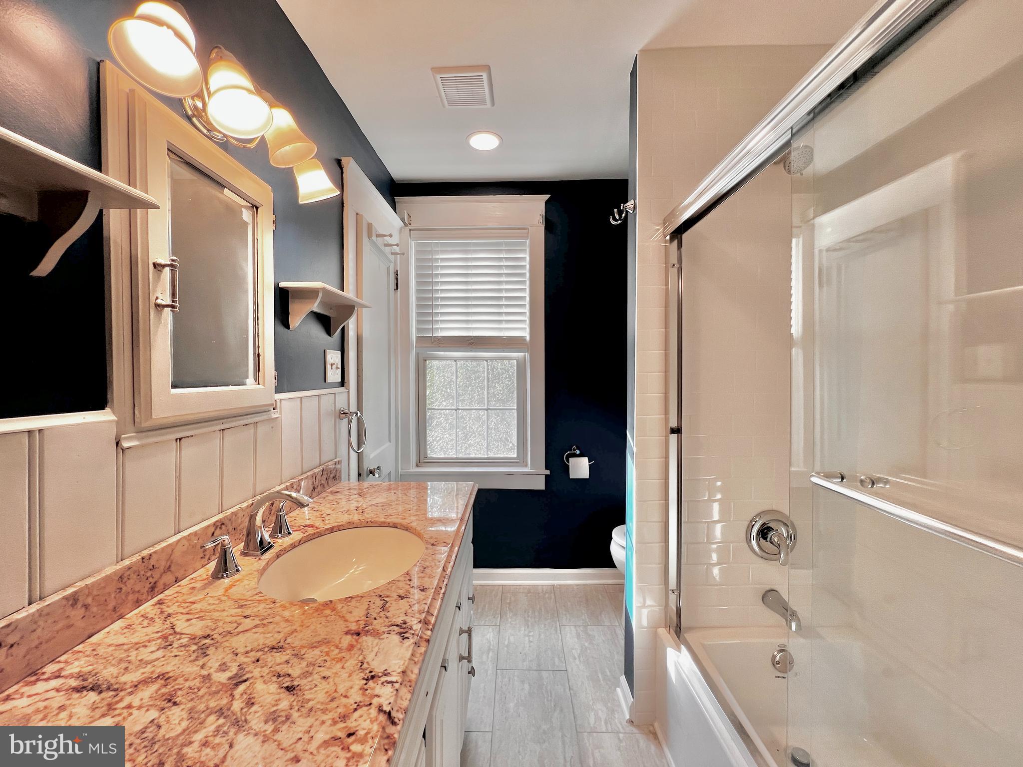 7041 Harvey Avenue Pennsauken, NJ 08109 - Photo 8 of 10 a bathroom with a tub a sink and a large mirror