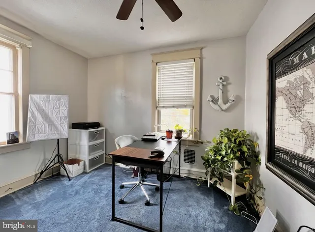 a workspace with furniture and window