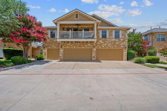 a front view of a house with a yard and a garage