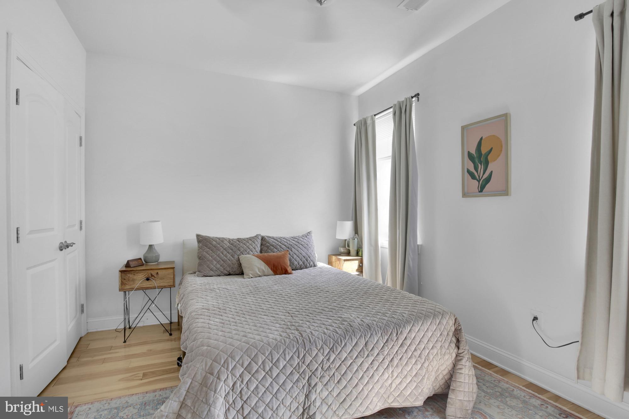 2302 Collins Street Philadelphia, PA 19125 - Photo 21 of 37 a bedroom with a bed and wooden floor