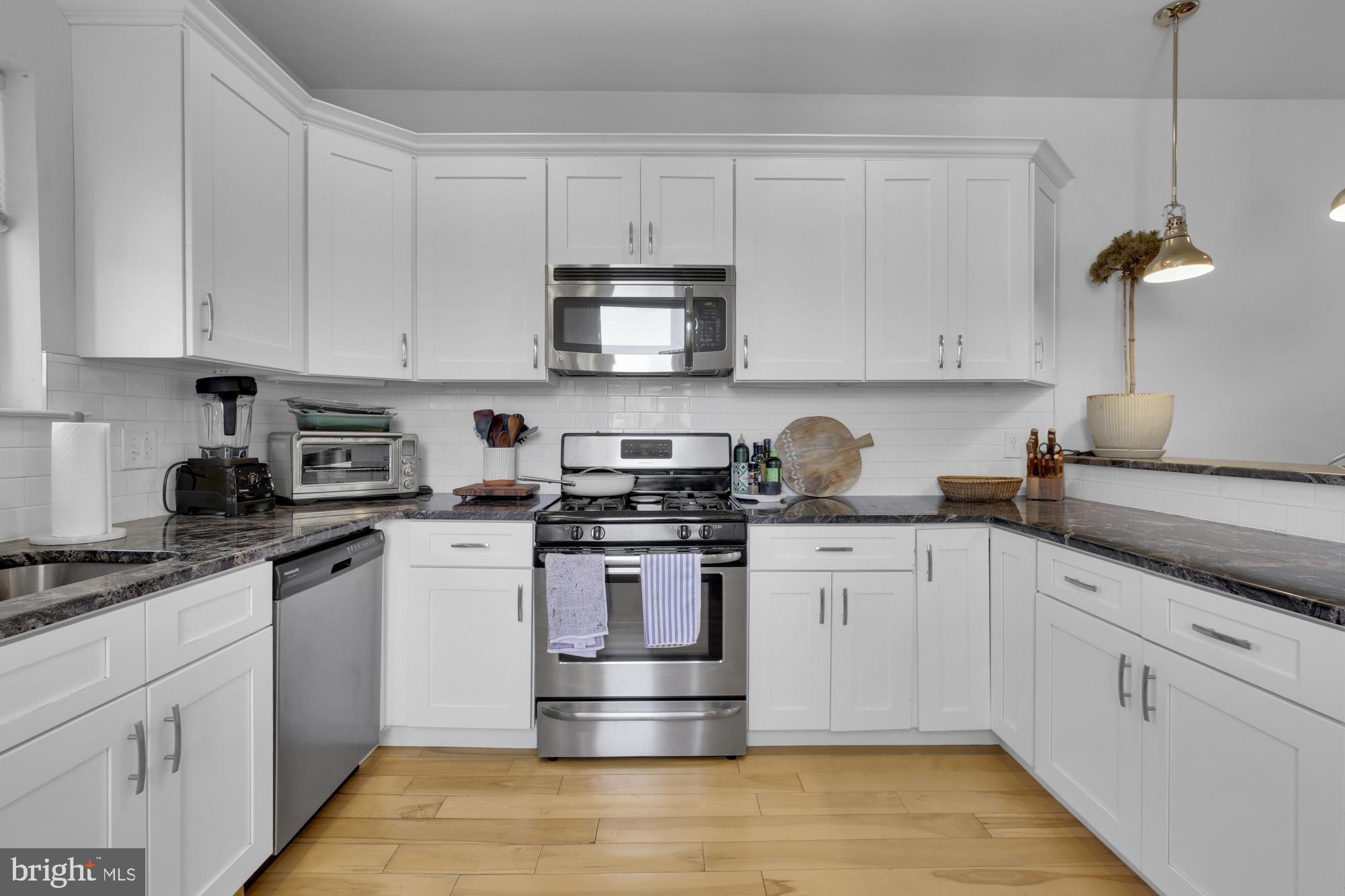 2302 Collins Street Philadelphia, PA 19125 - Photo 30 of 37 a kitchen with cabinets stainless steel appliances and a counter space