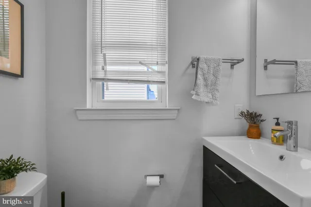 a bathroom with a sink and a window