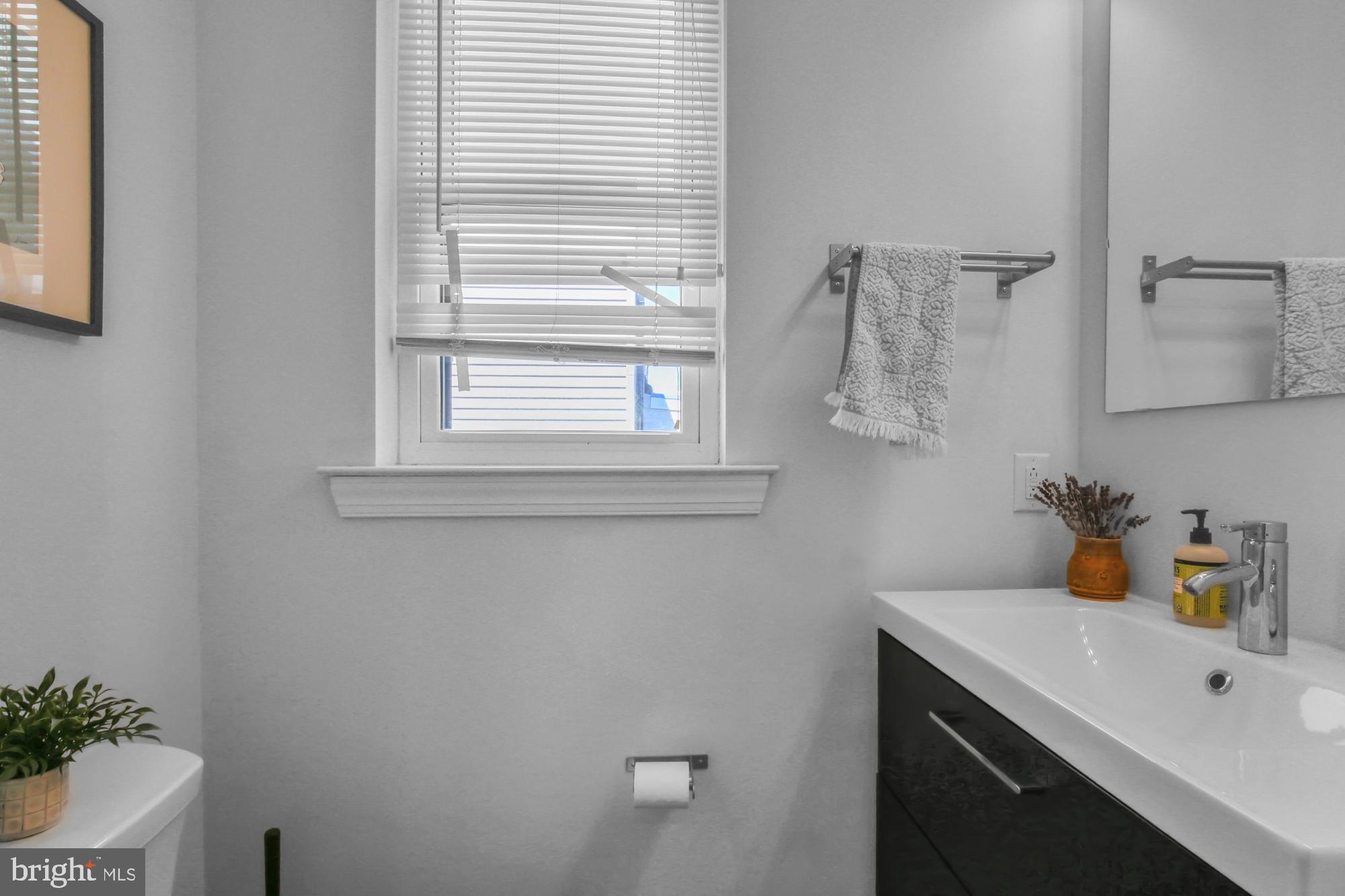 2302 Collins Street Philadelphia, PA 19125 - Photo 32 of 37 a bathroom with a sink and a window